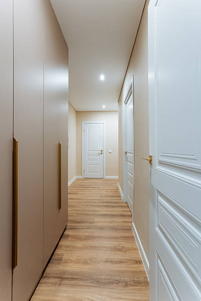 istock A beautifully designed hallway featuring elegant wooden floors complemented by pristine white doors within a stylish house. This creates an inviting atmosphere for everyone who enters 2211090207
