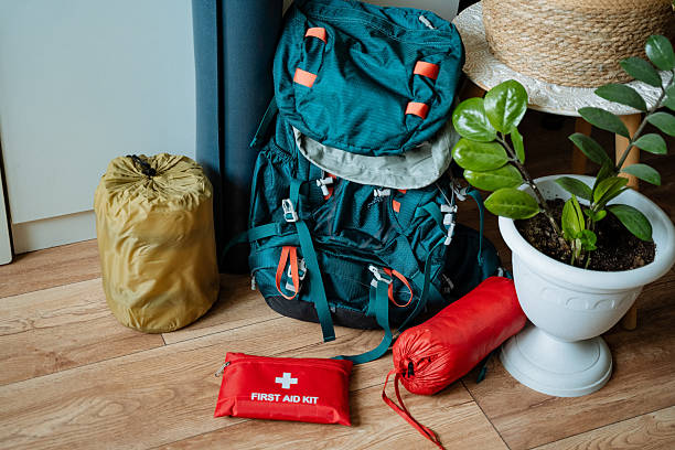 istock A backpack is sitting on a wooden floor next to a first aid kit 2211090209