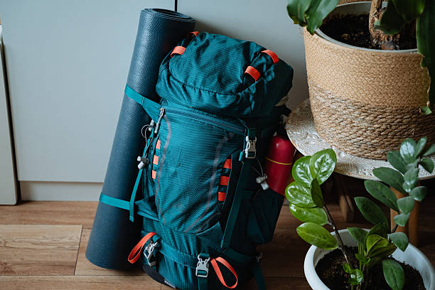 istock A bright blue backpack is casually resting on the polished wooden floor, positioned close to a neatly rolled yoga mat, which together creates a serene and peaceful atmosphere in the room 2211090239