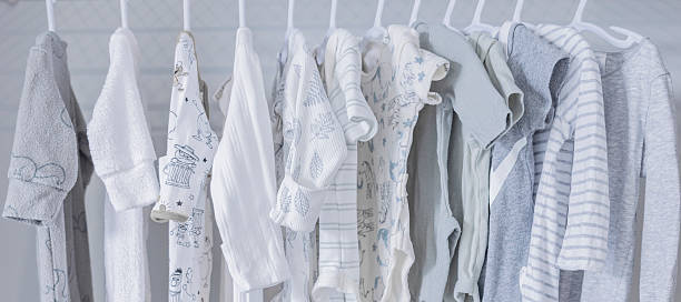 Baby clothes in a wardrobe on children's hangers