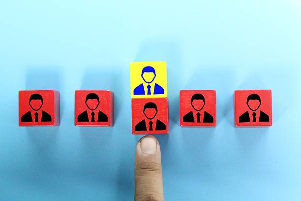 istock yellow cubes are exchanged for red cubes. symbolizing selection, leadership, or uniqueness. A human finger is pointing directly at this standout block, emphasizing the concept of choice, recruitment, or highlighting an individual from a group. 2211098323