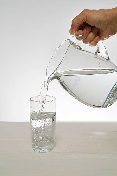 istock pitcher and glass of water 2211098564