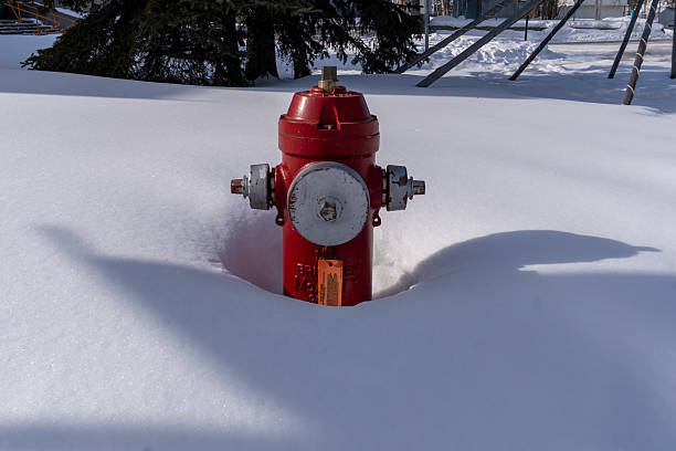 A fire hydrant partly buried by snow in Yellowknife, Northwest Territories, Canada