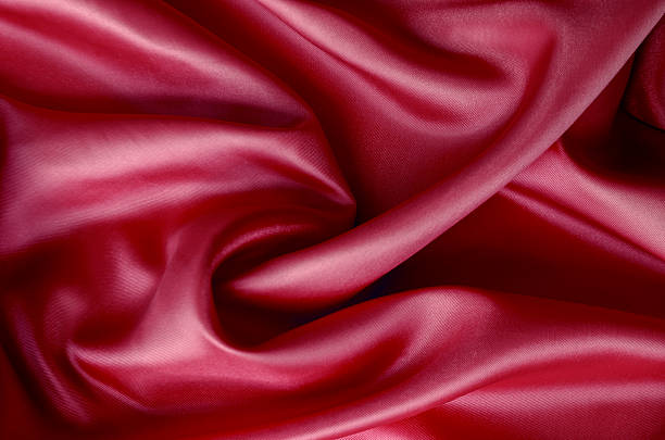istock Dark red silk with soft curves and vibrant reflective surface. Suitable for design and wallpaper background 2211101225
