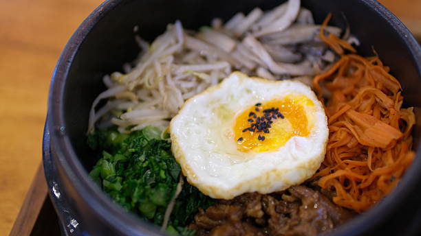 istock Bibimbap with fried egg in black bowl, Korean food. 2211111212