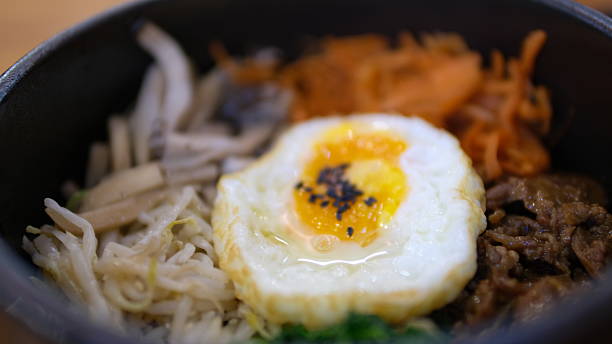 istock Bibimbap with fried egg in black bowl, Korean food. 2211111223