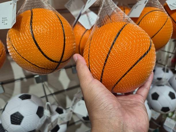 Hand Holding Small Basketball