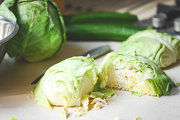 istock young white cabbage on the table, whole head and cut pieces 2211119162