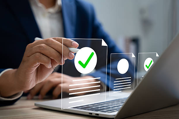istock Online survey and checklist assessment, Digital questionnaire, Businessman use tablet to complete a digital form, making evaluation and selecting correct answers marked with check marks. 2211119392