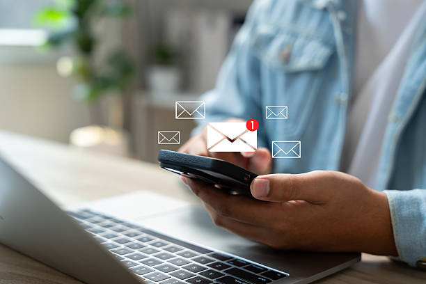istock New email notification alerts concept for Digital marketing business communication through virtual inbox and internet technology as Business people use smartphone with email on a virtual screen 2211119900