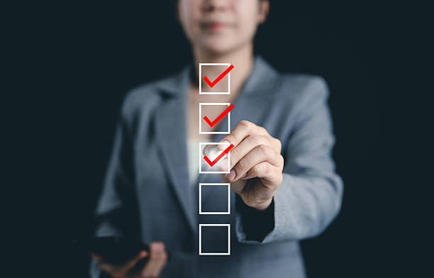 istock Online assessment and survey concept. Professional woman interacts with virtual checklist, symbolizing online assessments, surveys, exams, or quizzes. digital evaluation and data collection. fill out, 2211120885