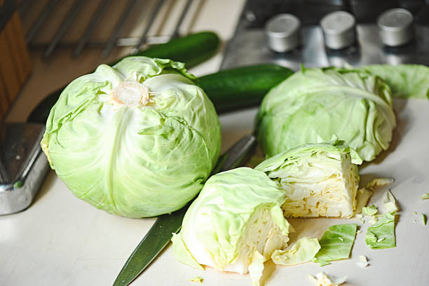 istock young white cabbage on the table, whole head and cut pieces 2211123478