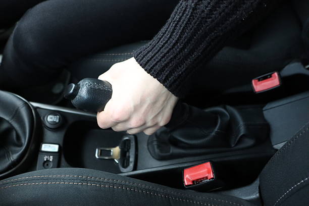 istock A hand positioned on the gear shift within the stylish and modern interior of a car 2211123761