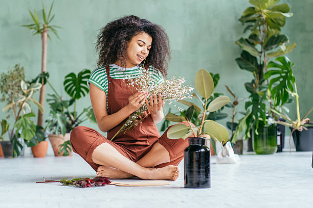 istock Young woman cultivating home plants 2211124982