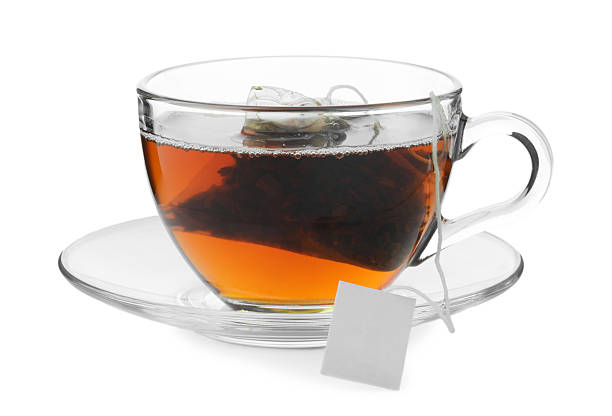 istock Tea bag in glass cup with hot drink isolated on white 2211125584