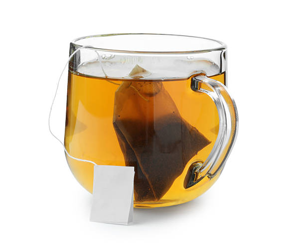 istock Tea bag in glass cup with hot drink isolated on white 2211125594
