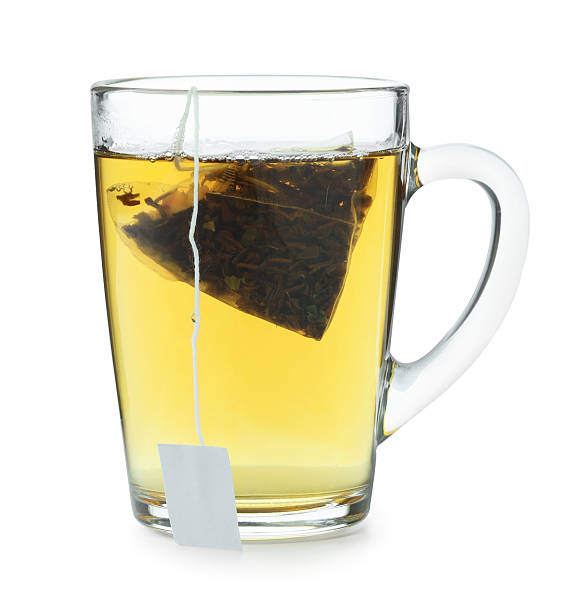 istock Tea bag in glass cup with hot drink isolated on white 2211125607