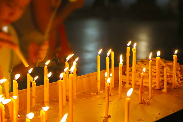 A collection of lit candles creates a warm and inviting atmosphere in a tranquil space, perfect for reflecting spiritual rituals and personal moments of peace.