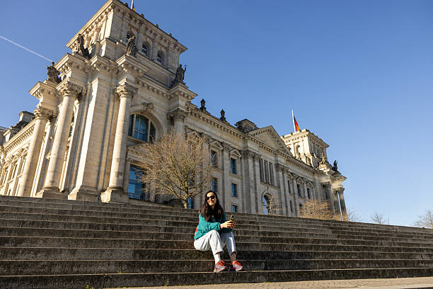 istock woman posing in front of historical building 2211131264