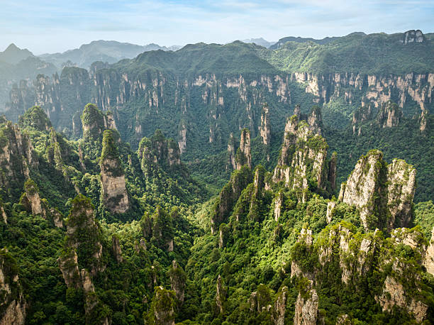 istock Aerial panorama capturing massive quartzite sandstone pillars rising through verdant foliage at Zhangjiajie National Forest Park, UNESCO World Heritage landscape in China 2211132562