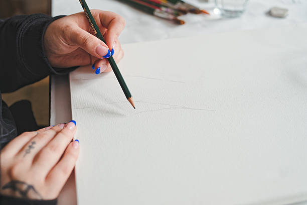 istock Young woman drawing a sketch on painters canvas 2211132584
