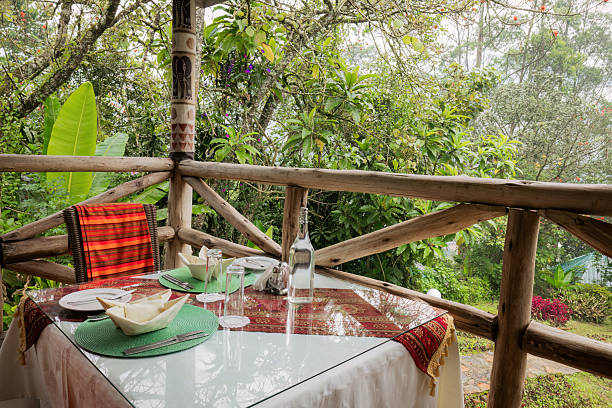 istock Two-Person Table Setting on Forest Lodge Veranda 2211133227