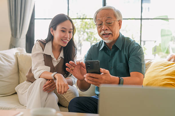 istock Asian senior father takes help in his smartphone, regarding a new application based on the latest technology Young woman daughter teach help in smartphone apllication use 2211134808
