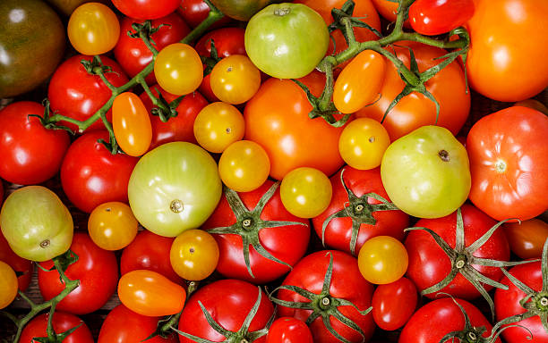 istock mix of fresh tomatoes as background, top view 2211135100