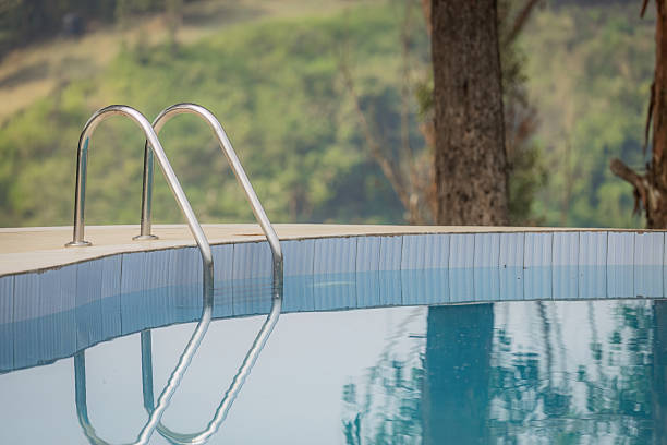 istock Close-Up of Pool Ladder at Infinity Pool Overlooking Forested Hills 2211136487
