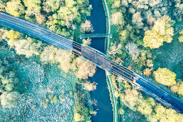 A train passing over a bridge over a river Wey near Guildford Surrey England Europe