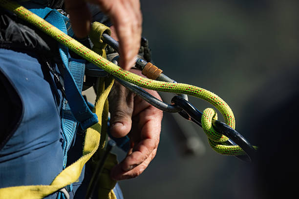 istock Hand Gripping Climbing Rope with Carabiner 2211138385