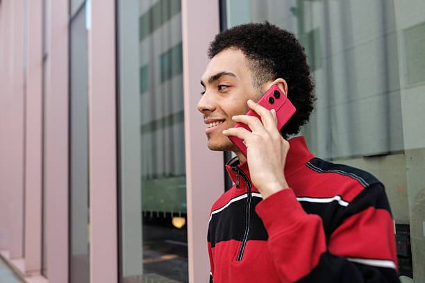 istock Young man talking on mobile phone in urban setting 2211138640