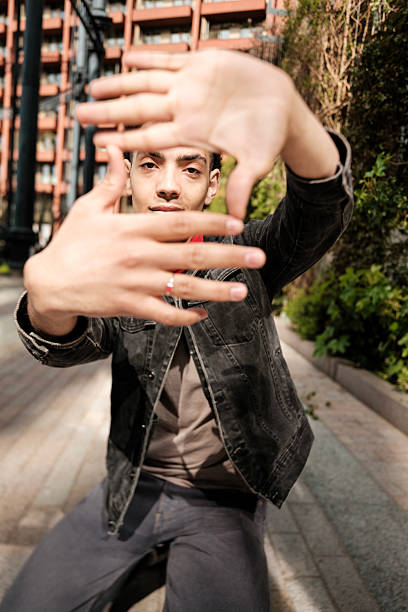 istock Young man framing with hands in urban setting 2211138674