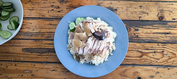 istock Chicken rice in a blue plate on a wooden table 2211139338