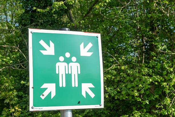 istock Assembly point sign indicating gathering place for people in case of emergency 2211140738