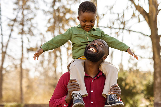 istock Excited Child Riding on Father’s Shoulders 2211140926