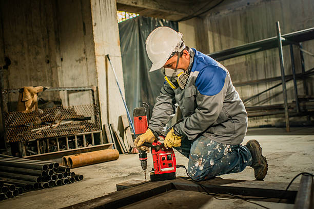 istock Technician installing electrical wiring on construction site with appropriate machinery - stock photo 2211141096