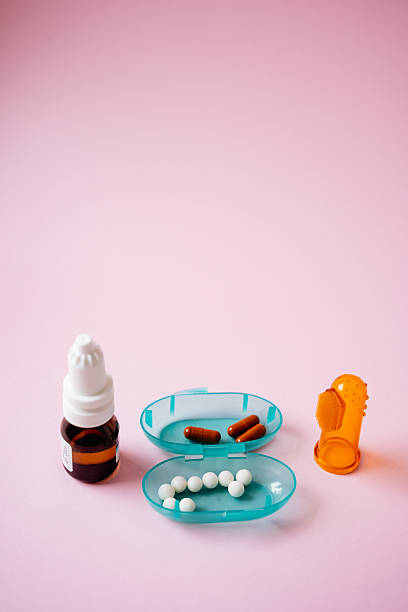 istock In a visually appealing setup, a bottle filled with an assortment of colorful pills, alongside a distinct container also holding more pills, rests on a vibrant pink background 2211144264