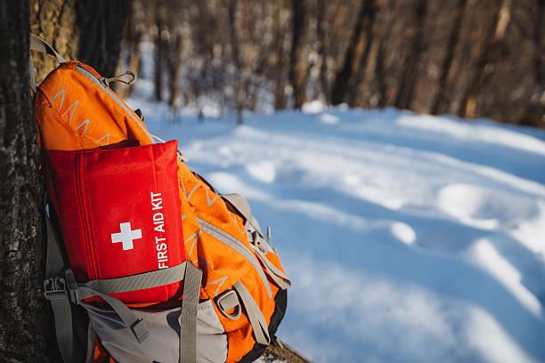 istock On a snowy landscape, a first aid kit is perched atop an orange backpack, which is part of essential hiking and outdoor equipment, ready for any winter adventure or emergency situation 2211144342