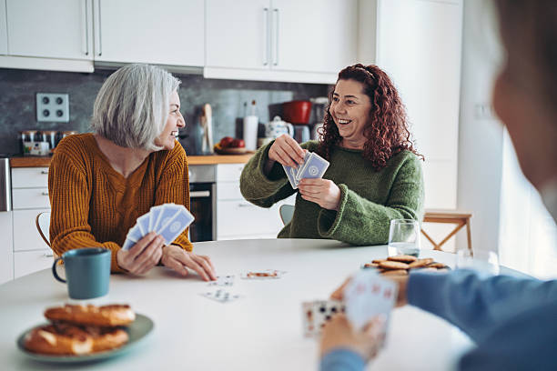 istock Mature women friends playing cards 2211145733