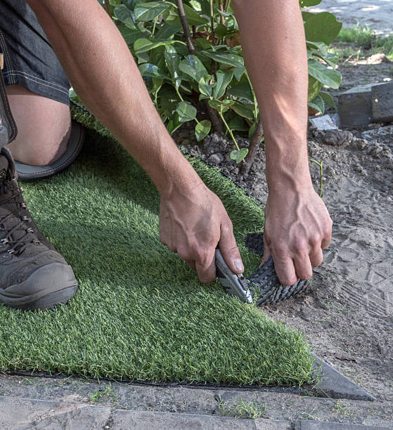 istock Cutting artifical grass with a stanley knife. 2211146560