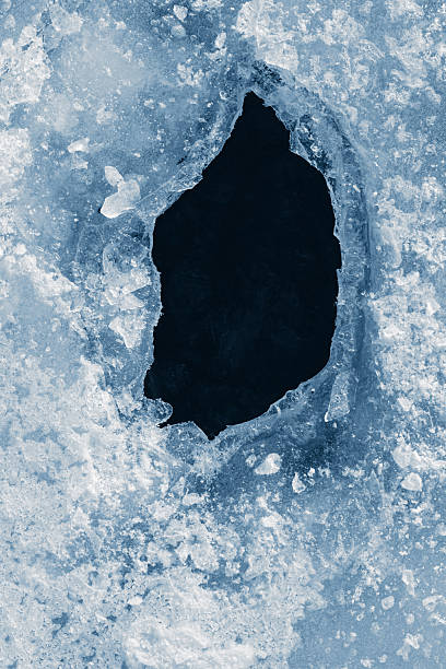 istock Hole in the textured natural ice. 2211147291