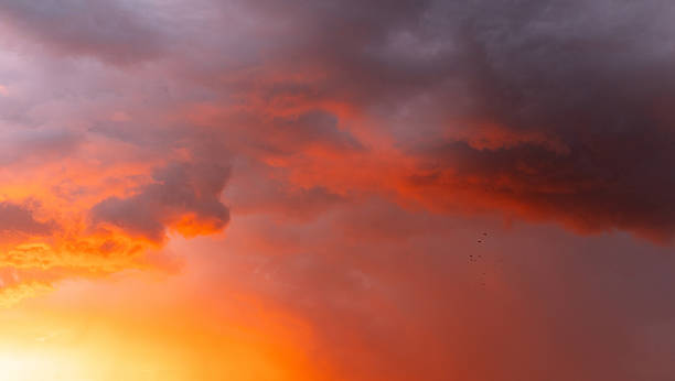 istock Dramatic, colorful, red-painted cloudy sky at sunset. Clouds' texture, abstract nature, background. 2211147884