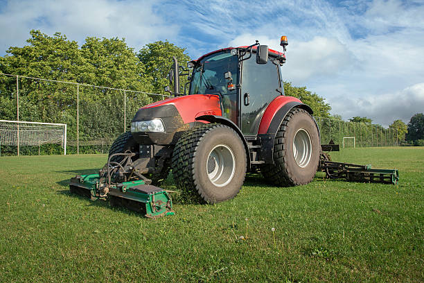 Worker driving forklift at agriculture field of Slovenian village of Zabnica on a cloudy summer day. Photo taken August 10th, 2023, Zabnica, Kranj, Slovenia.