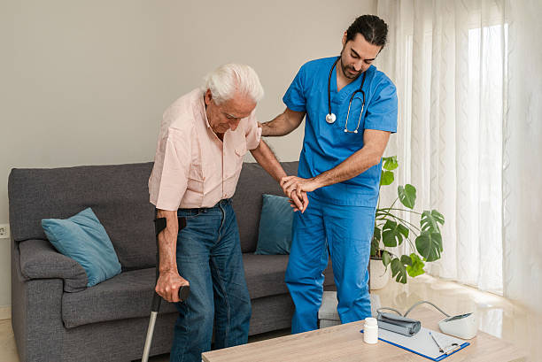 istock Male nurse assisting elderly man using crutch at home 2211150844
