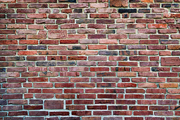 istock Rustic Red Brick Wall Texture. A detailed image of a rustic red brick wall showcasing various shades and textures. 2211156028