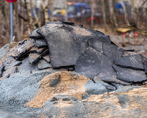 istock Pile of broken asphalt rubble at construction site.. 2211156472