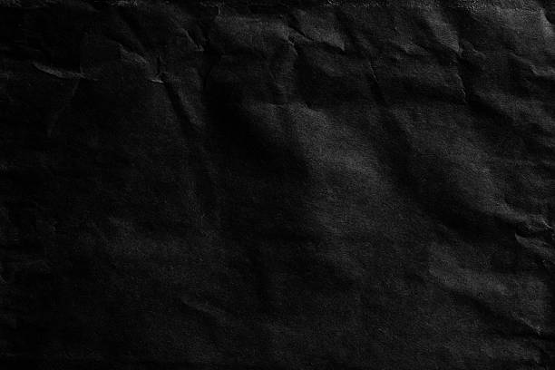 istock Black crumpled paper texture closeup 2211160017