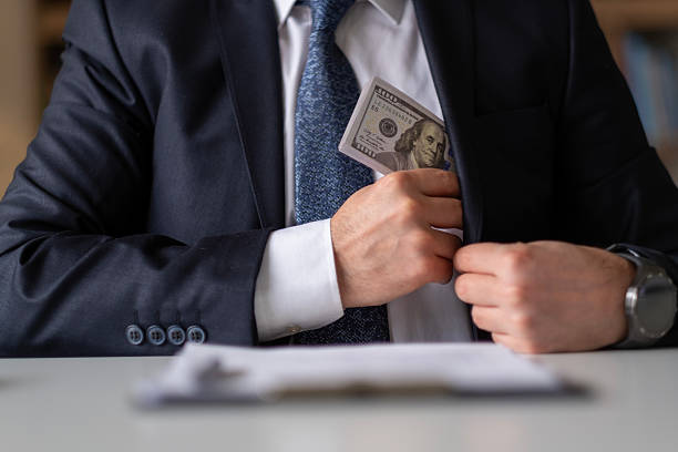 Man in Suit Concealing Cash in Envelope