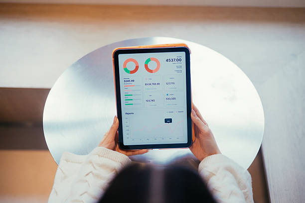 istock Person Holding a Tablet Displaying Financial Analytics and Business Insights 2211164604